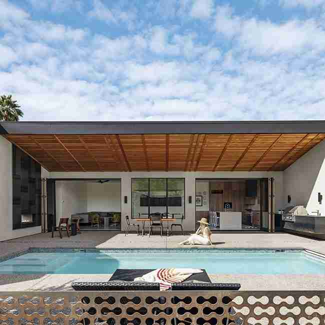 Modern butterfly roof home with floor-to-ceiling wall system windows